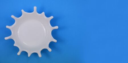 White splash stock images. White splash on blue background. White milk drop. White Bowl on Blue Background with Copy Space for Textの写真素材