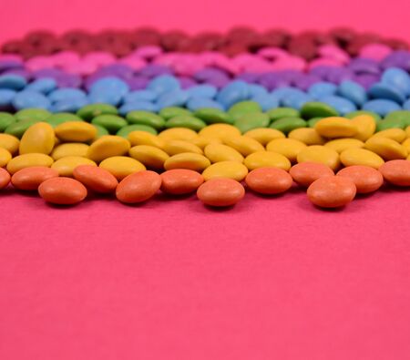 Colorful candies on pink background stock images. Sweets on a pink background. Colorful candies...