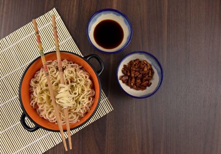 Chinese noodles in bowl stock photography Chinese noodles still life. Bowl of Chinese noodles with chopstick on wooden background stock imagesの写真素材
