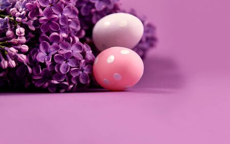 Beautiful Easter decoration with lilac and eggs stock images. Syringa with easter eggs stock images. Easter decoration on a purple background. Spring decoration images. Lilac flower frame stock imagesの写真素材