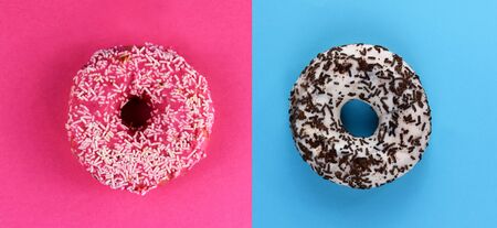 Donuts on a pink and blue background top view stock images. Donut with icing on a blue and pink...