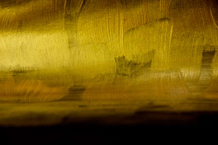 Luxury abstract golden black paint background stock images. Elegant abstract gold black background with brush stroke photo images. Festive background with copy space for text. Gold brush strokes imageの写真素材