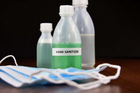 Hand sanitizer gel with protective face mask stock images. Protective equipment against COVID-19. Sanitizer gel bottle with medical mask stock photoの写真素材