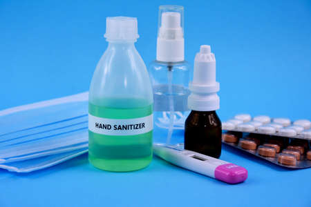 Hand sanitizer gel, medication, thermometer and protective face mask stock images. Protective...