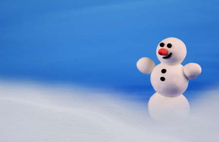 Cute snowman on a blue background stock images. Winter landscape with snowman images. Happy snowman in winter scenery. Holiday blue background with snowmanの写真素材