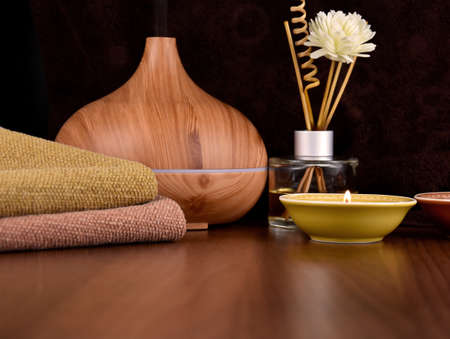 Flower and wooden scented stick stock images. Scented stick, wooden humidifier and candles close-up. Spa and wellness setting images. Spa still life with interior fragrance sticks stock photoの写真素材