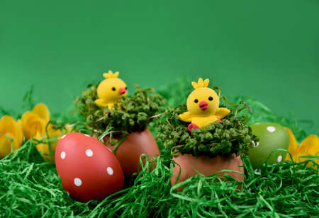 Cute easter baby chicks toys on a green background stock images. Little yellow chickens easter...