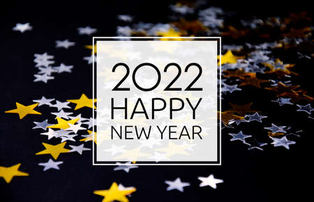2022 Happy New Year black background frame with golden stars stock images. 2022 New Year sign on a starry background. Happy New Year 2022 with golden and silver shiny stars greeting card imagesの写真素材