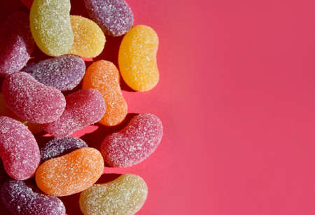 Sour jelly candy on a pink background frame stock images. Sour sweets isolated on a pink background with copy space for textの写真素材