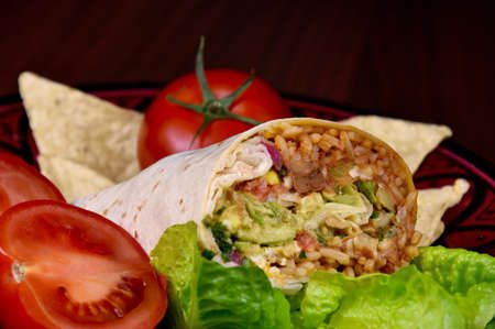 Burrito wrap with vegetable close-up stock images. Traditional mexican food images. Vegetarian bean and rice burrito still life stock photoの写真素材
