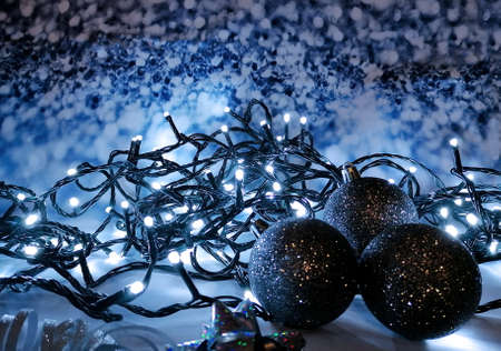 Blue christmas still life with light chain stock images. Christmas garland lights and balls close up stock photo. Cold blue christmas decorations stock imagesの写真素材