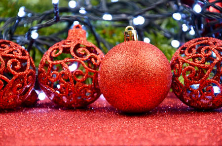 Beautiful red Christmas glitter ball with light Christmas garland stock images. Red bauble decoration with lights still life stock photo. Red shiny christmas ornament imagesの写真素材
