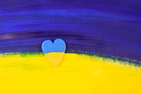 Abstract painted flag of Ukraine with heart shape stock images. Russian invasion of ukraine symbol. Grunge Ukrainian flag stock photoの写真素材