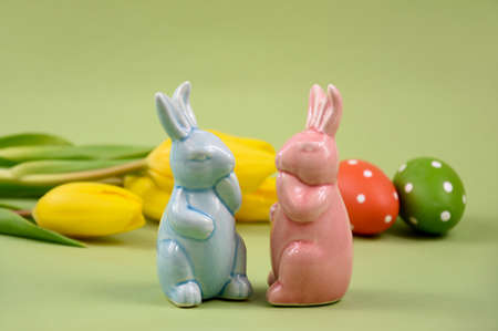 Two cute easter bunnies figurines stock images. Blue and pink easter bunny spring decoration still...