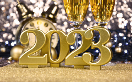 New Year 2023 golden candles still life stock photo images. New Year's Eve party 2023 golden shiny...