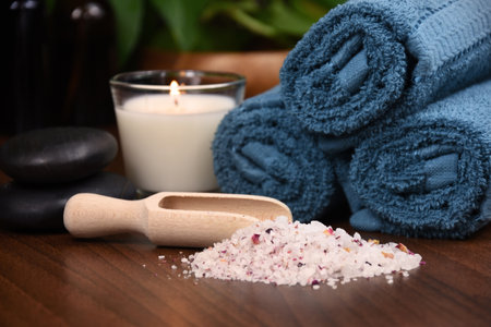 Blue-green towels, salt and candle on wooden background spa still life stock photo images. Spa and wellness setting with towels, candles and bath salt photo. Beauty spa treatmentの写真素材
