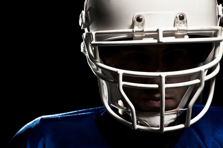 Football Player with number on a blue uniform and a ball in the hand  Studio shot 