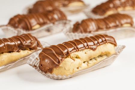 Bomba de chocolate. A Brazilian traditional eclair on a white background.