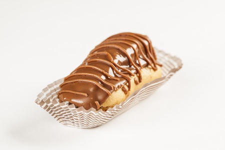 Bomba de chocolate. A Brazilian traditional eclair on a white background.
