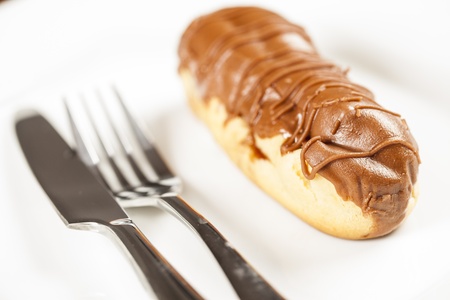 Bomba de chocolate. A Brazilian traditional eclair on a white background.