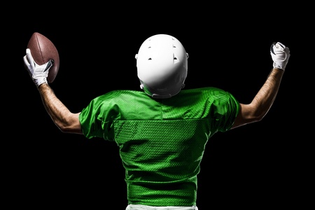 Football Player with a Green uniform celebrating on a black background.