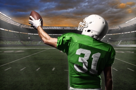 Football Player with a green uniform celebrating with the fans. Football Player with a green uniform celebrating with the fans.