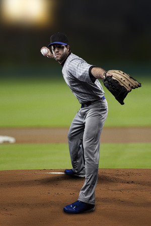 Pitcher Baseball Player on a Blue Uniform on baseball Stadium.の写真素材
