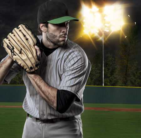 Baseball Player on a Green Uniform on baseball Stadium.