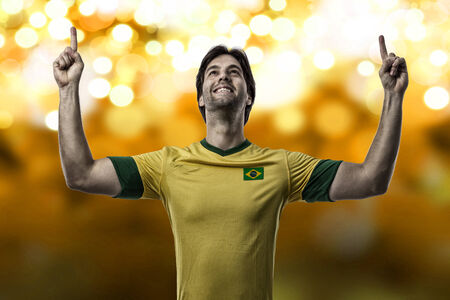 Brazilian soccer player, celebrating on a Yellow lights background.の写真素材
