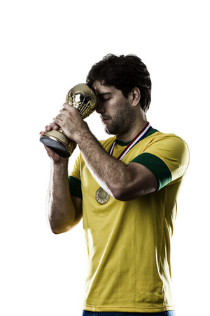 Brazilian soccer player, celebrating the championship with a trophy in his hand, on a white background.の写真素材