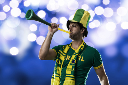 Brazilian Fan Celebrating, on a blue background.の写真素材