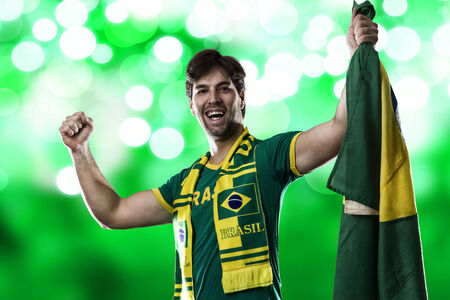 Brazilian Fan Celebrating, on a green .の写真素材