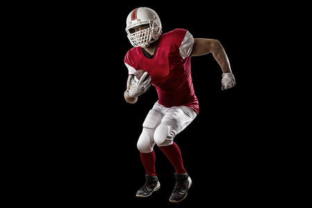 Football Player with a red uniform Running on a Black background.の写真素材