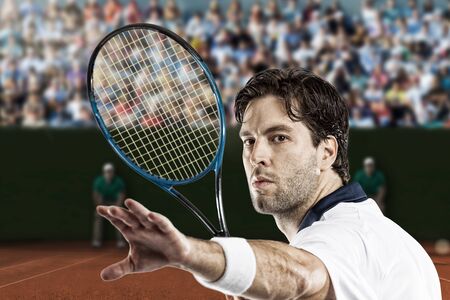 Tennis player playing on a clay tennis court.の写真素材