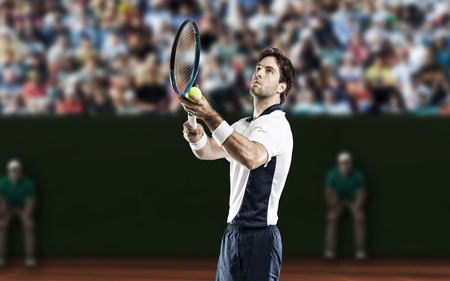 Tennis player playing on a clay tennis court.の写真素材