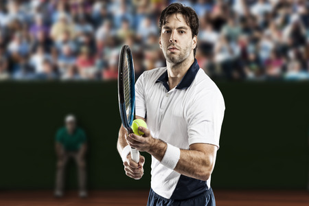 Tennis player playing on a clay tennis court.の写真素材