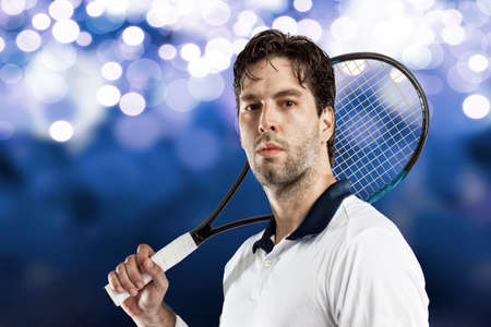 Tennis player playing on blue lights background.