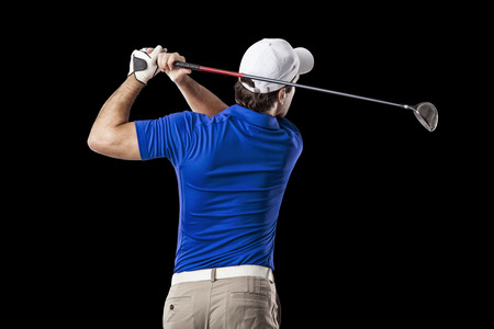 Golf Player in a blue shirt taking a swing, on a black Background.