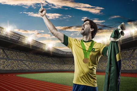 Brazilian Athlete Winning a golden medal on a Track and field stadium.の写真素材