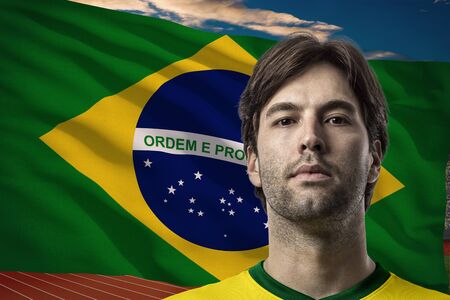 Brazilian Athlete in front of a brazilian flag.の写真素材