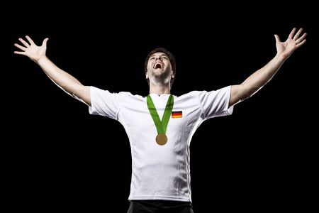 German Athlete Winning a golden medal on a black Background.の写真素材