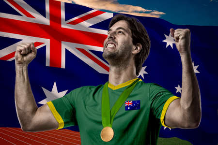 Australian Athlete Winning a golden medal in front of a Australian flag.の写真素材