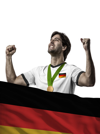German Athlete Winning a golden medal with a German flag in front.の写真素材