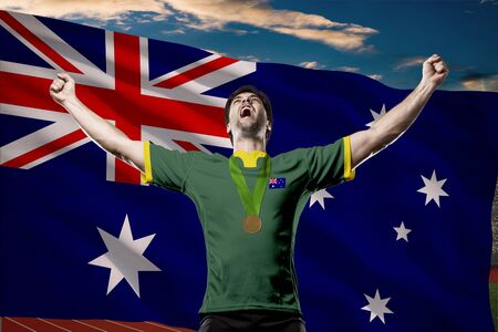 Australian Athlete Winning a golden medal in front of a Australian flag.の写真素材