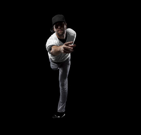 Pitcher Baseball Player with a white uniform on a black background.の写真素材