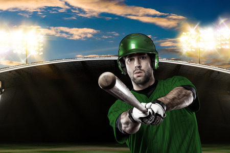 Baseball Player with a green uniform on baseball Stadium.の写真素材