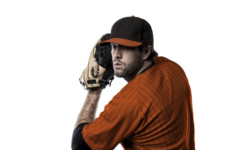 Pitcher Baseball Player with a orange uniform on a white background.の写真素材