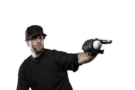 Baseball Player with a black uniform on a white background.の写真素材