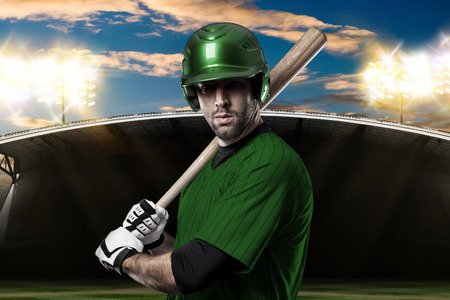 Baseball Player with a green uniform on baseball Stadium.の写真素材