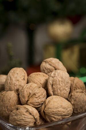 Walnuts in front of a Christmas treeの写真素材
